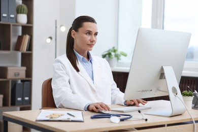 Photo of Doctor having online consultation via computer in clinic