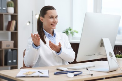 Photo of Doctor having online consultation via computer in clinic