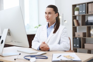 Photo of Doctor having online consultation via computer in clinic
