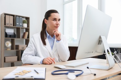 Photo of Doctor having online consultation via computer in clinic