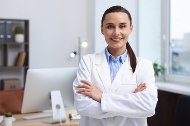 Photo of Portrait of happy doctor in uniform indoors, space for text