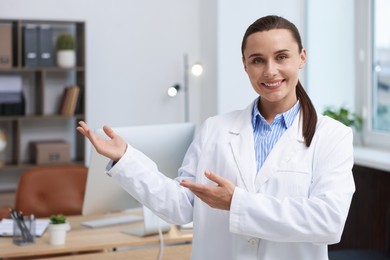 Photo of Portrait of happy doctor in uniform indoors