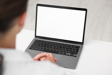 Photo of Doctor having online consultation via laptop in clinic, closeup