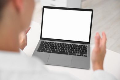 Photo of Doctor having online consultation via laptop in clinic, closeup