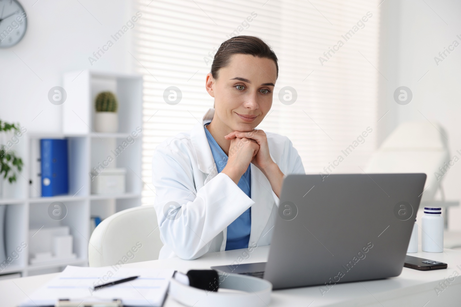 Photo of Doctor having online consultation via laptop in clinic