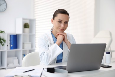 Photo of Doctor having online consultation via laptop in clinic