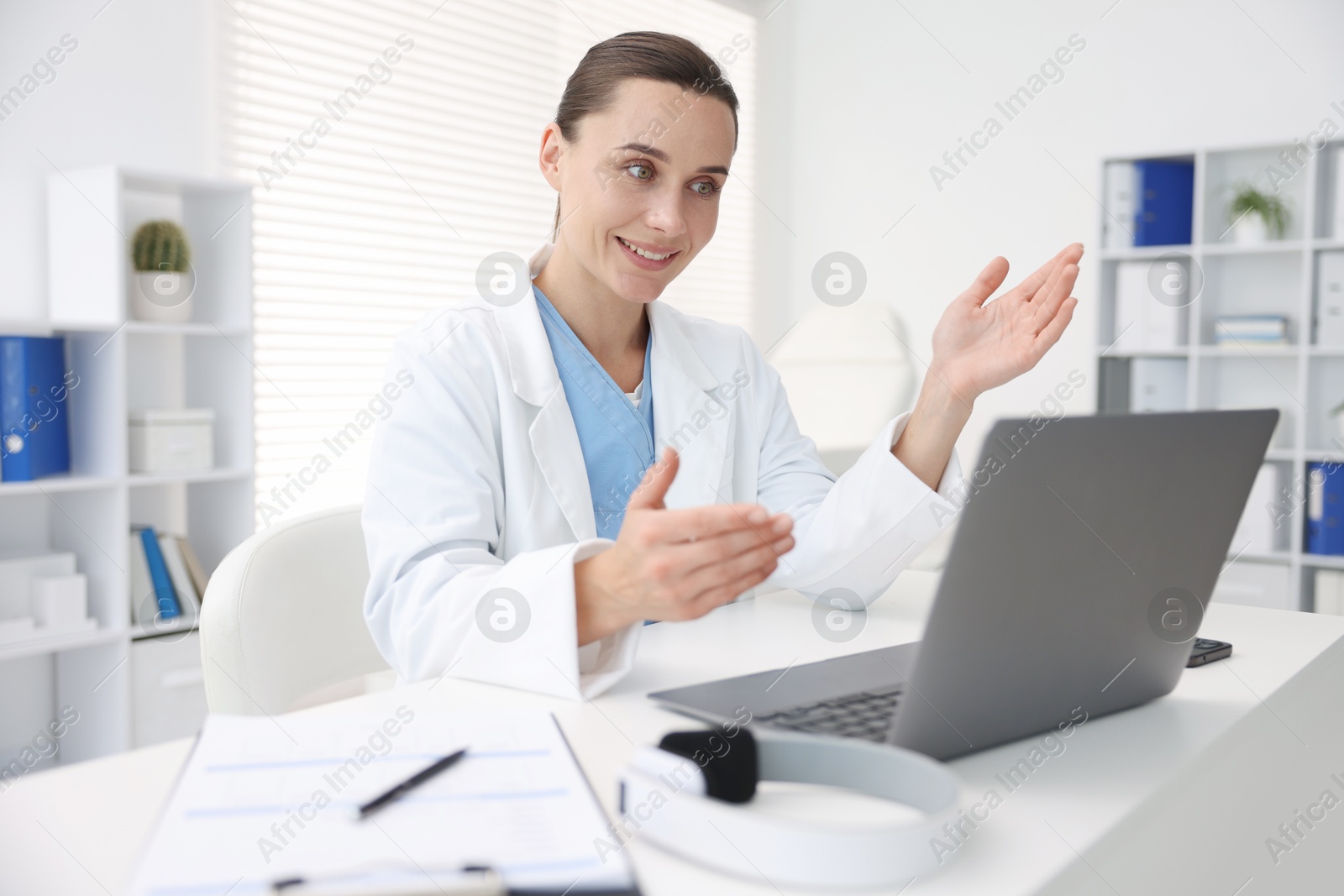 Photo of Doctor having online consultation via laptop in clinic