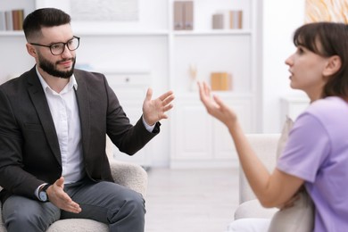 Photo of Professional psychologist working with patient in office, selective focus