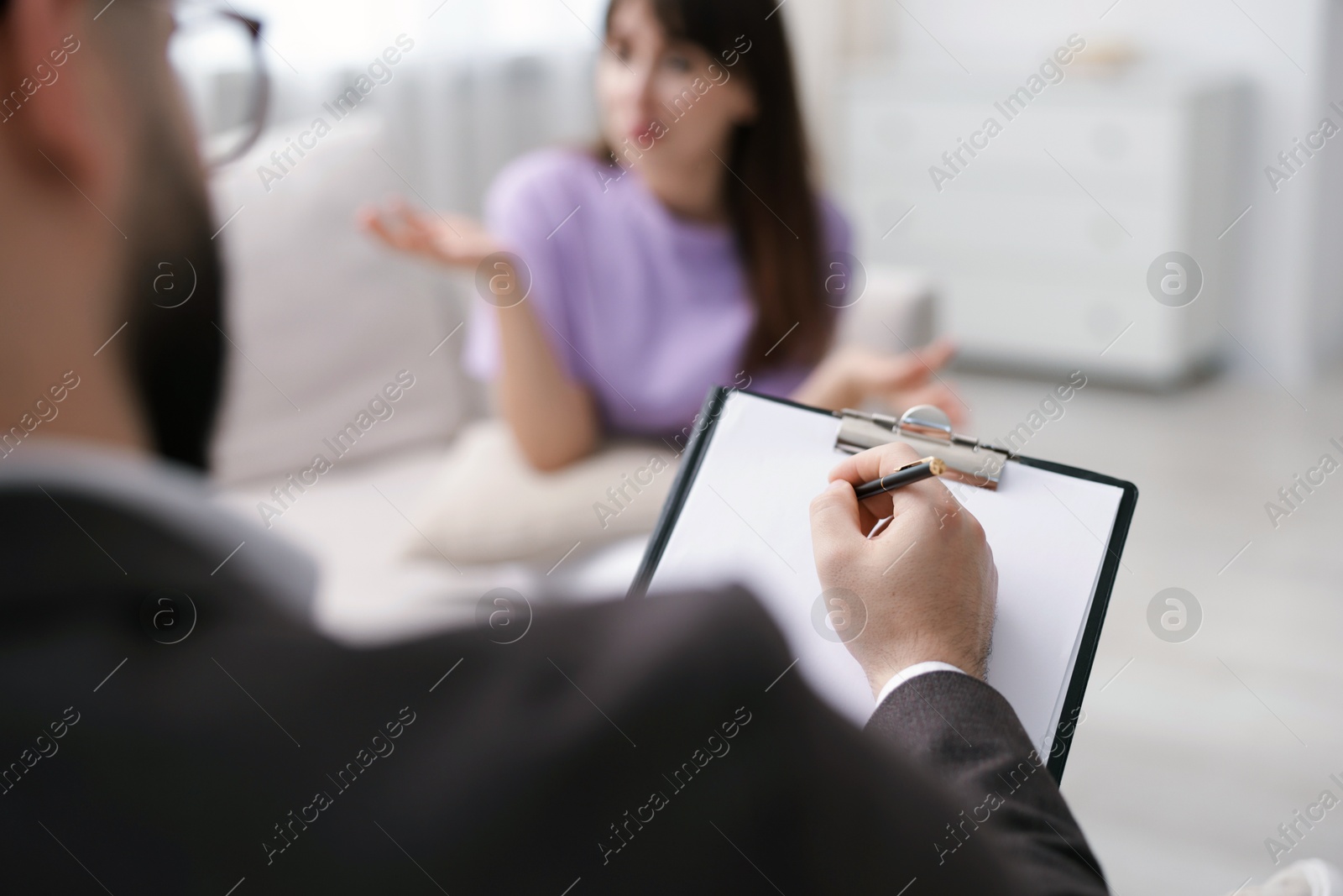 Professional psychologist working with patient in office, selective focus Photo of Professional psychologist working with patient in office, selective focus