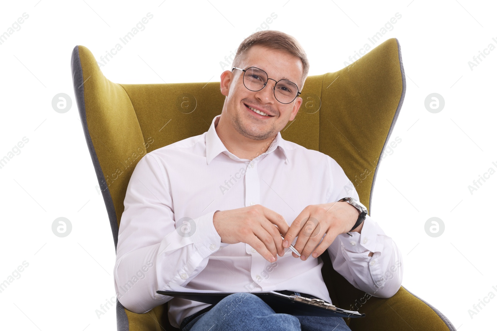 Photo of Smiling psychologist in glasses with clipboard sitting on armchair against white background
