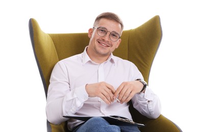 Photo of Smiling psychologist in glasses with clipboard sitting on armchair against white background