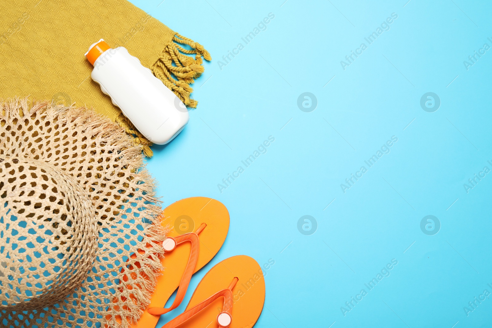 Flat lay composition with beach towel and other summer accessories on light blue background. Space for text Photo of Flat lay composition with beach towel and other summer accessories on light blue background. Space for text