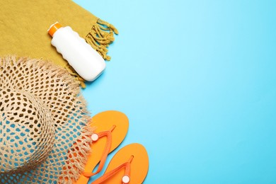 Photo of Flat lay composition with beach towel and other summer accessories on light blue background. Space for text