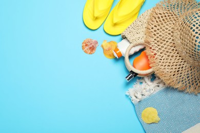 Photo of Flat lay composition with beach towel and other summer accessories on light blue background. Space for text