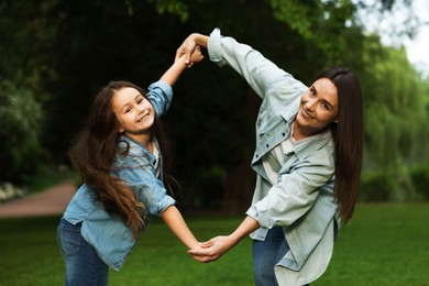 Photo of Family getaway. Happy mother and daughter spending time together in park