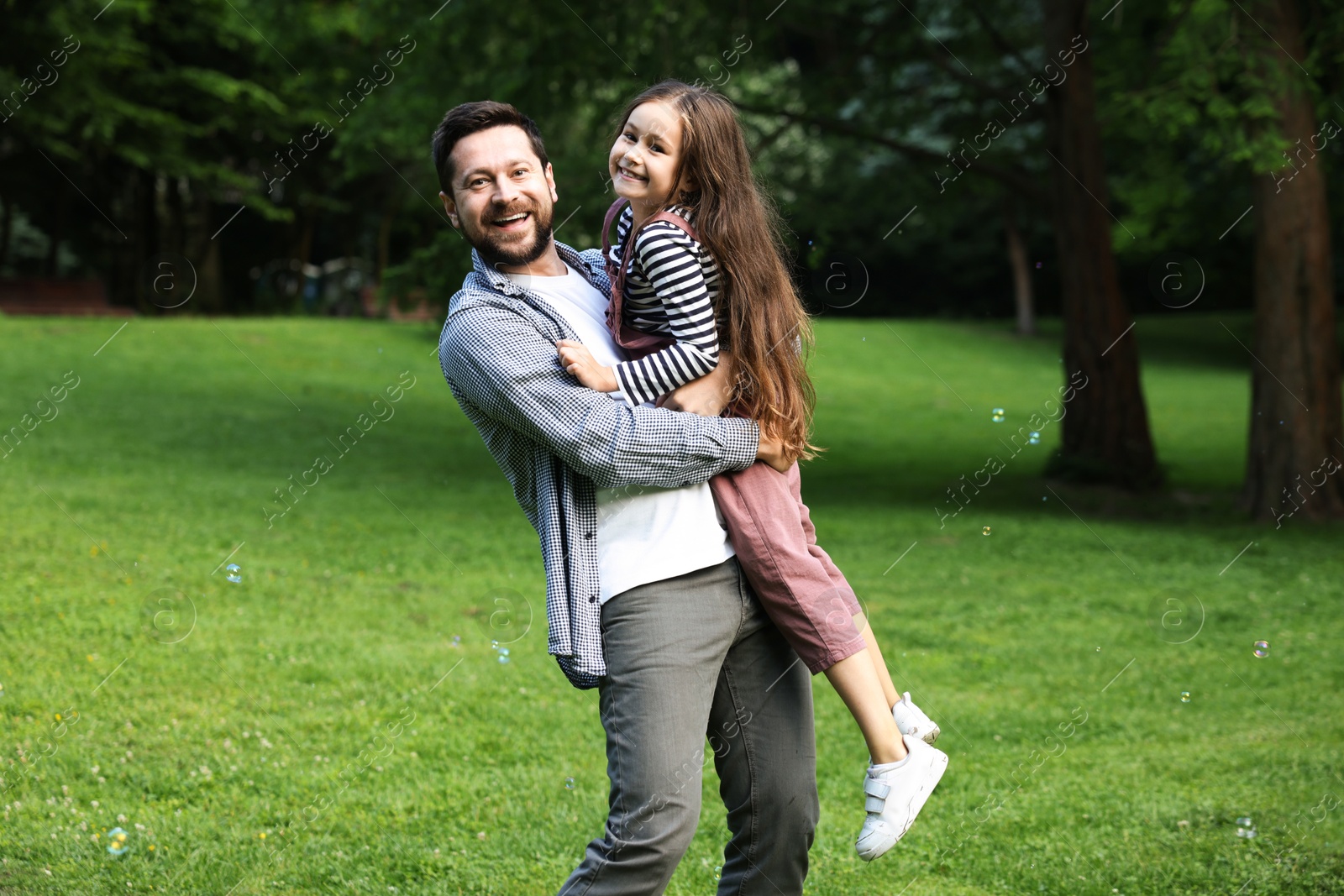 Family getaway. Happy father and daughter having fun in park Photo of Family getaway. Happy father and daughter having fun in park