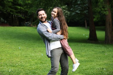 Photo of Family getaway. Happy father and daughter having fun in park