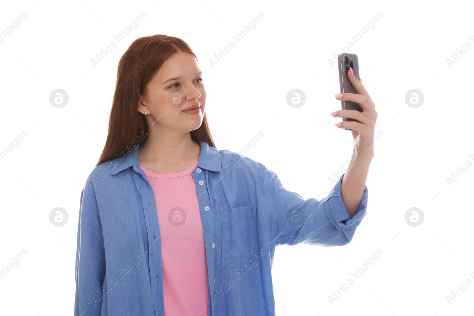 Beautiful teenage girl taking selfie by smartphone on white background Photo of Beautiful teenage girl taking selfie by smartphone on white background
