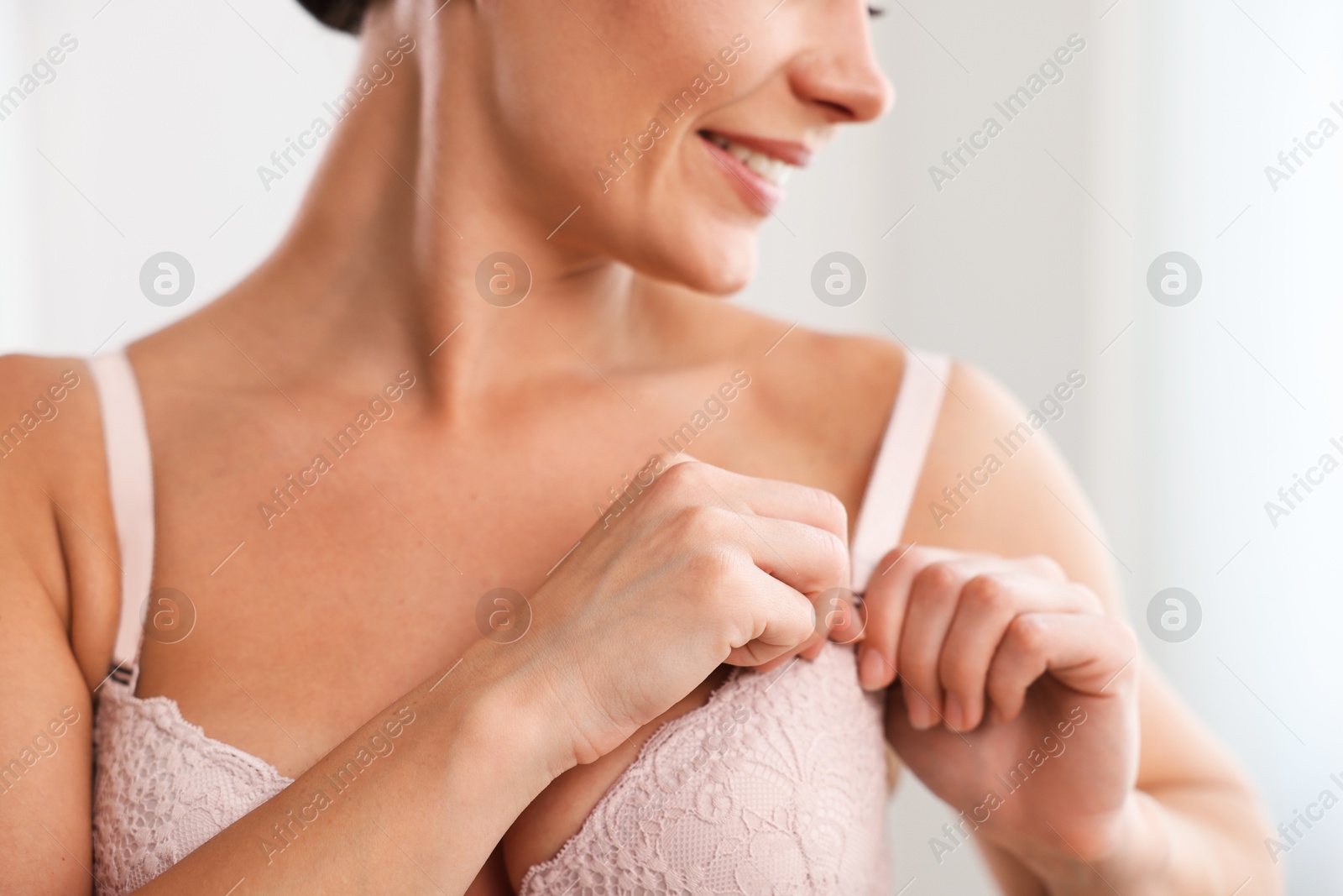 Woman wearing beautiful bra at home, closeup Photo of Woman wearing beautiful bra at home, closeup