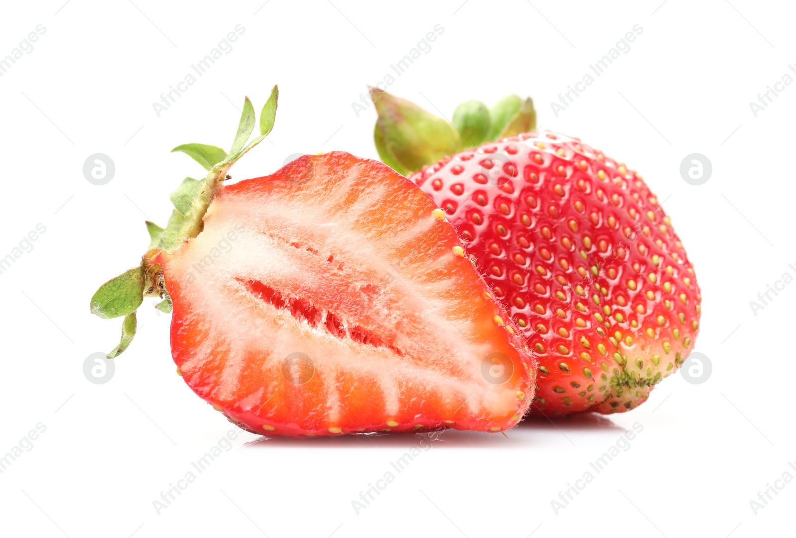 Whole and cut strawberries isolated on white Photo of Whole and cut strawberries isolated on white