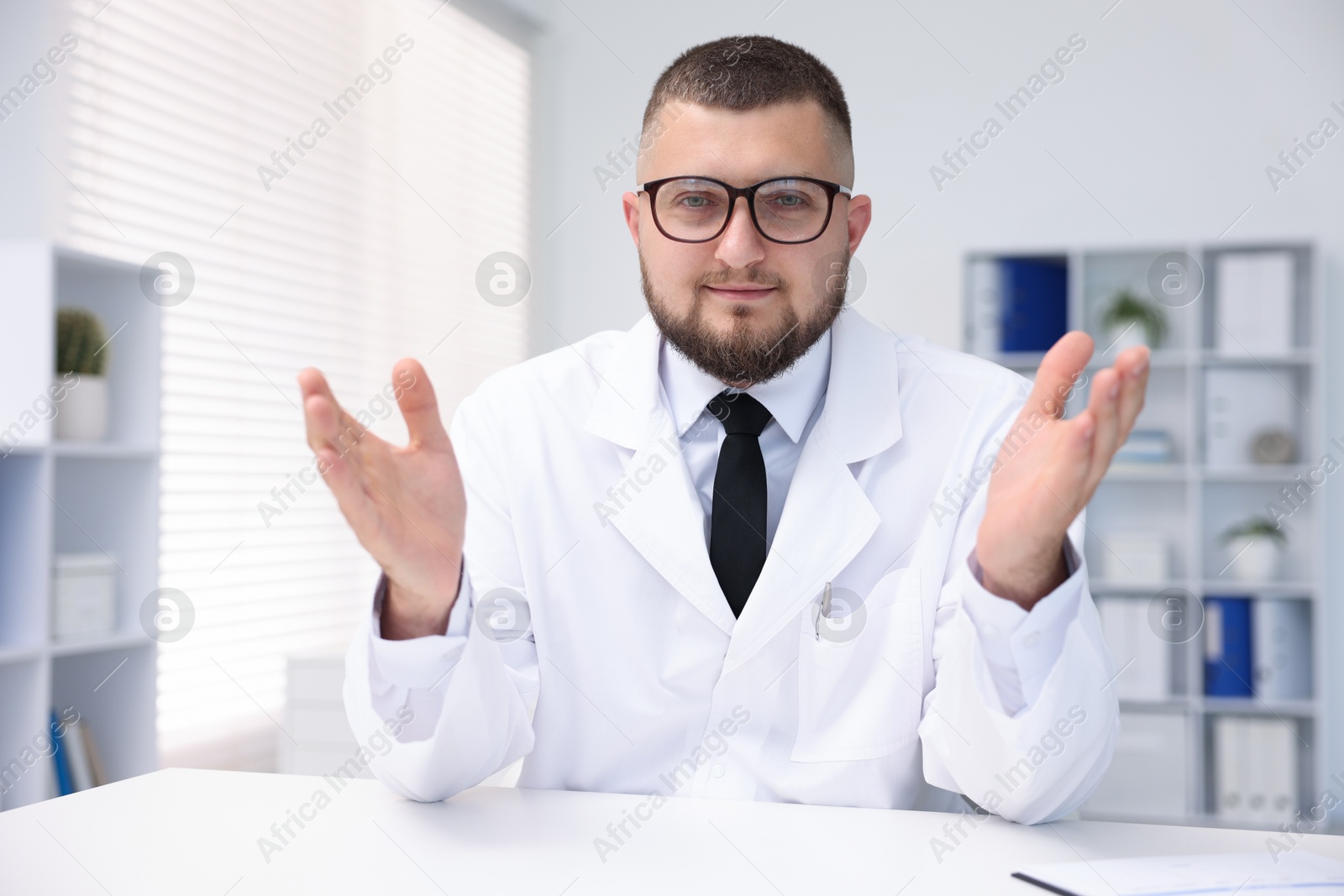 Portrait of doctor in uniform at table indoors Photo of Portrait of doctor in uniform at table indoors