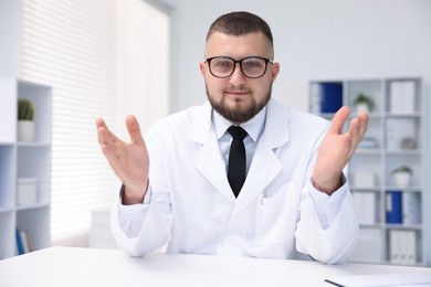 Photo of Portrait of doctor in uniform at table indoors