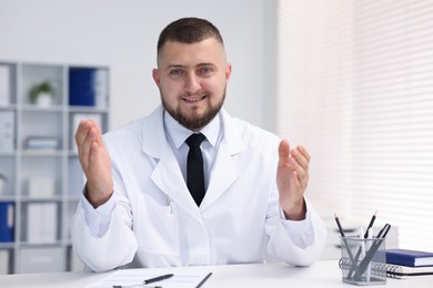 Photo of Portrait of doctor in uniform at table indoors