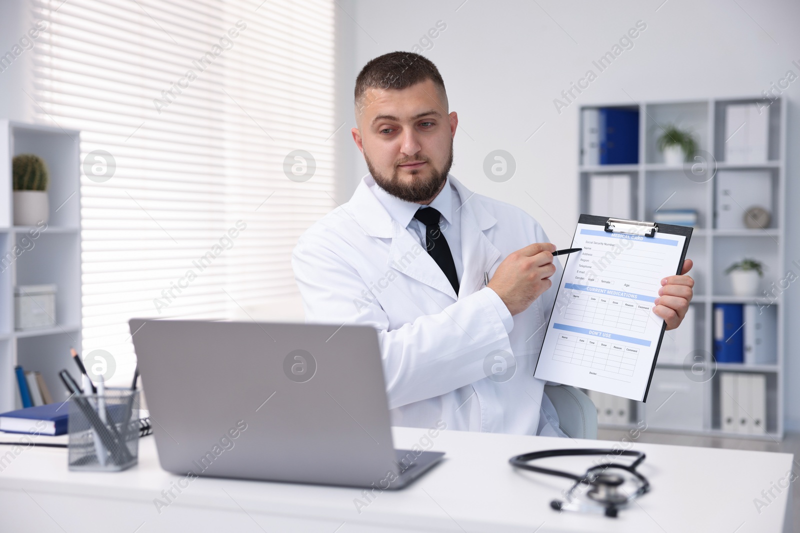 Doctor having online consultation via laptop in clinic Photo of Doctor having online consultation via laptop in clinic