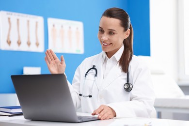 Photo of Doctor having online consultation via laptop in clinic