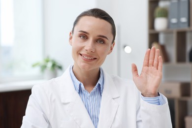 Photo of Portrait of happy doctor in uniform indoors
