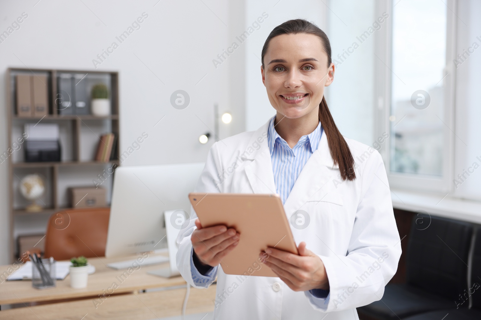 Photo of Doctor using tablet in clinic, space for text. Online medical consultation