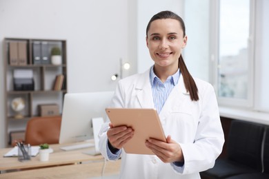 Photo of Doctor using tablet in clinic, space for text. Online medical consultation