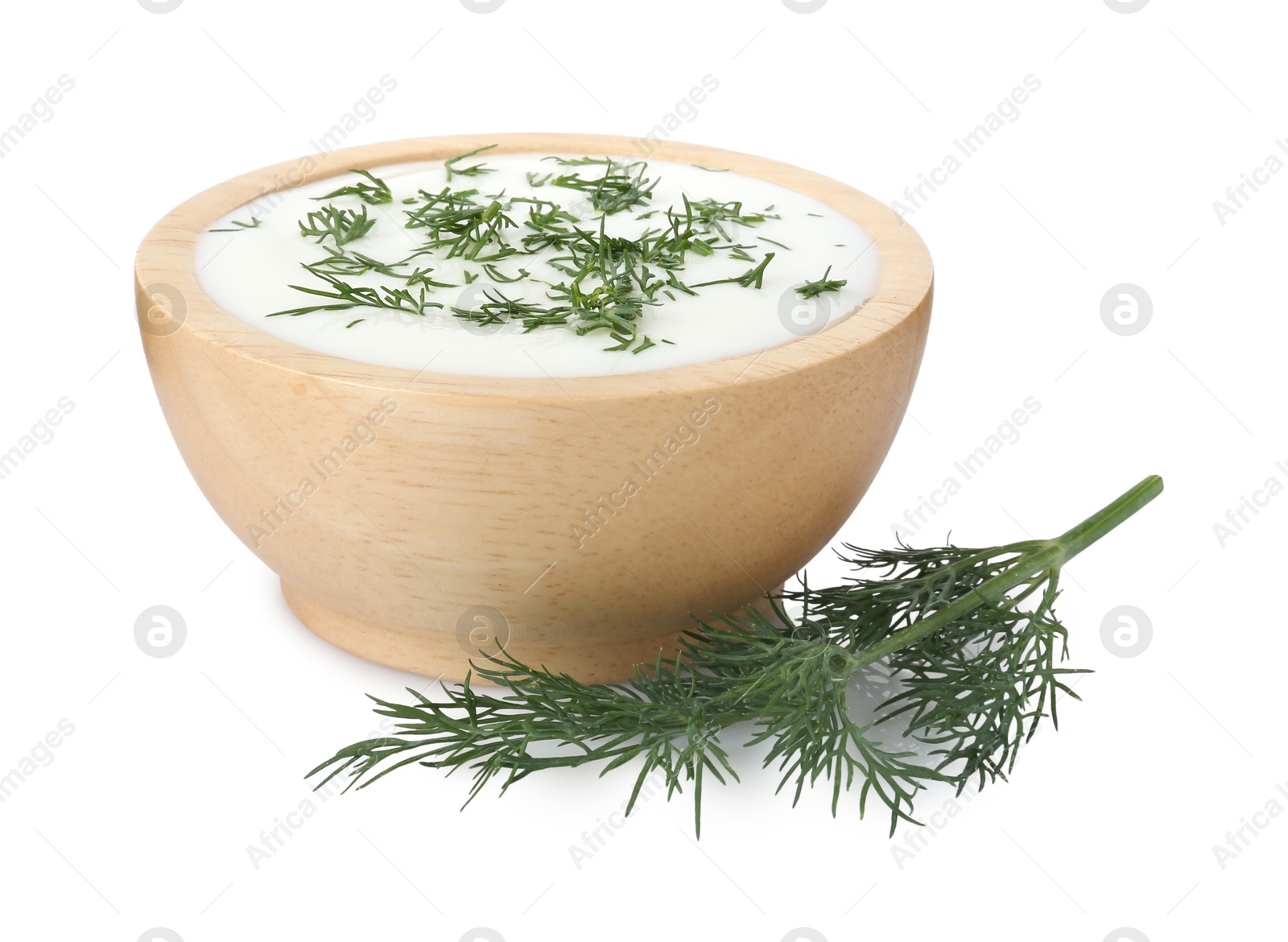 Delicious yogurt in bowl and dill isolated on white Photo of Delicious yogurt in bowl and dill isolated on white