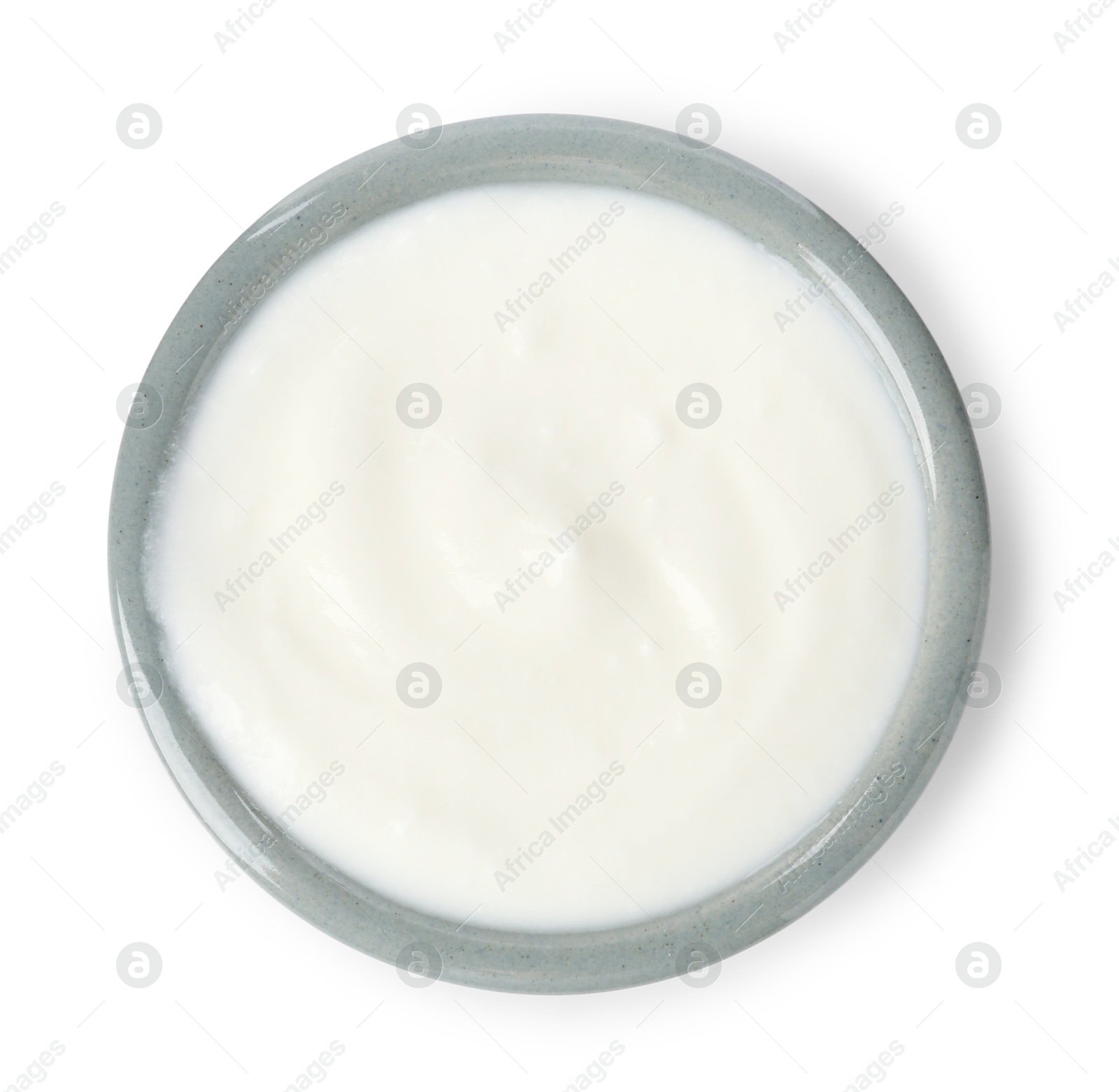 Photo of Delicious yogurt in bowl isolated on white, top view