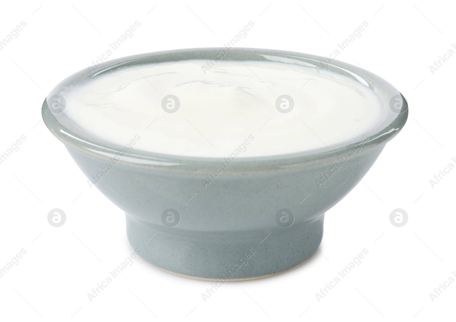 Photo of Delicious yogurt in bowl isolated on white