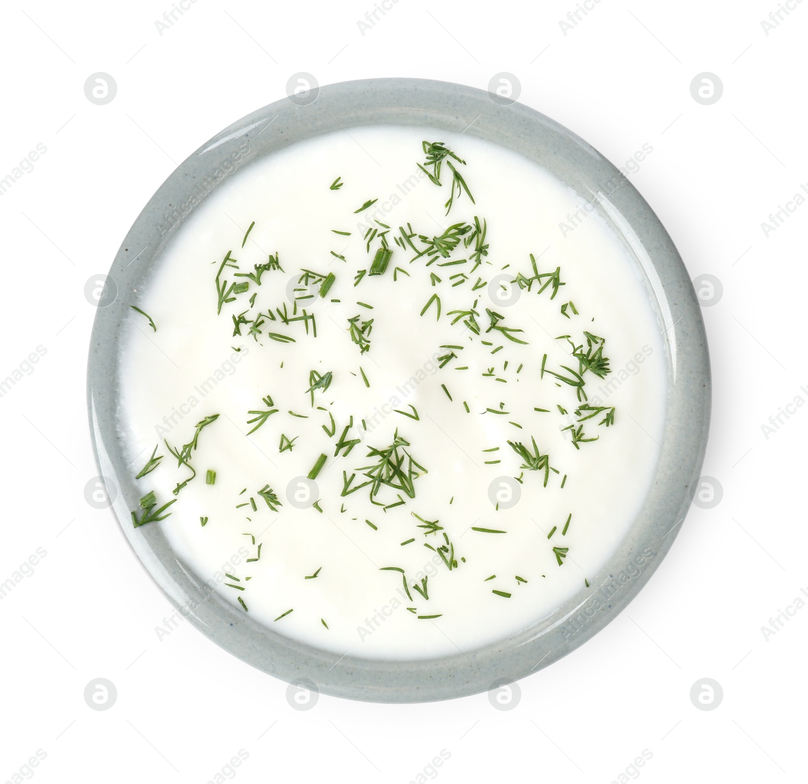 Photo of Delicious yogurt with dill in bowl isolated on white, top view