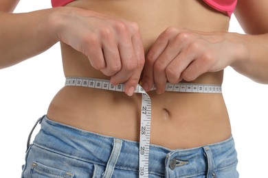 Photo of Woman measuring waist circumference on white background, closeup