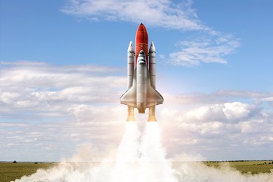 Image of Launch of space rocket in field on sunny day