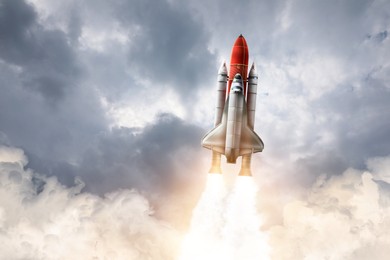 Image of Modern space rocket in beautiful cloudy sky