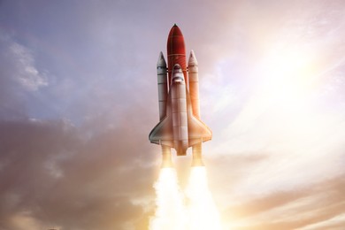 Image of Modern space rocket in beautiful cloudy sky