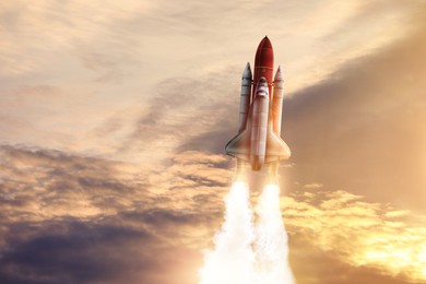 Image of Modern space rocket in beautiful cloudy sky