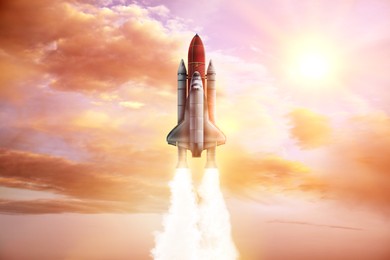 Image of Modern space rocket in beautiful cloudy sky