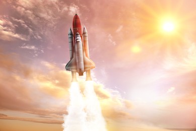 Image of Modern space rocket in beautiful cloudy sky