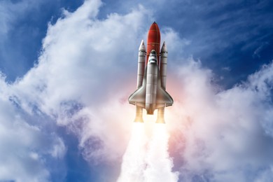 Image of Modern space rocket in beautiful cloudy sky