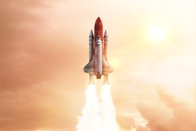 Image of Modern space rocket in beautiful cloudy sky
