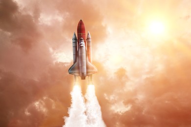 Image of Modern space rocket in beautiful cloudy sky