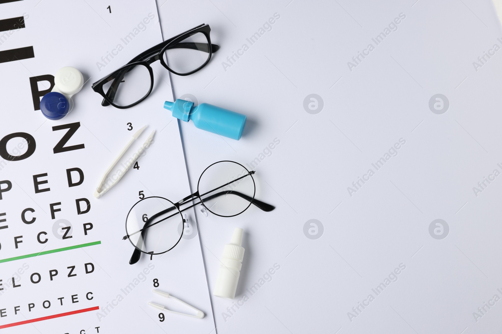 Vision test chart, glasses, tweezers, bottles of medical drops and lenses on white background, flat lay. Space for text Photo of Vision test chart, glasses, tweezers, bottles of medical drops and lenses on white background, flat lay. Space for text