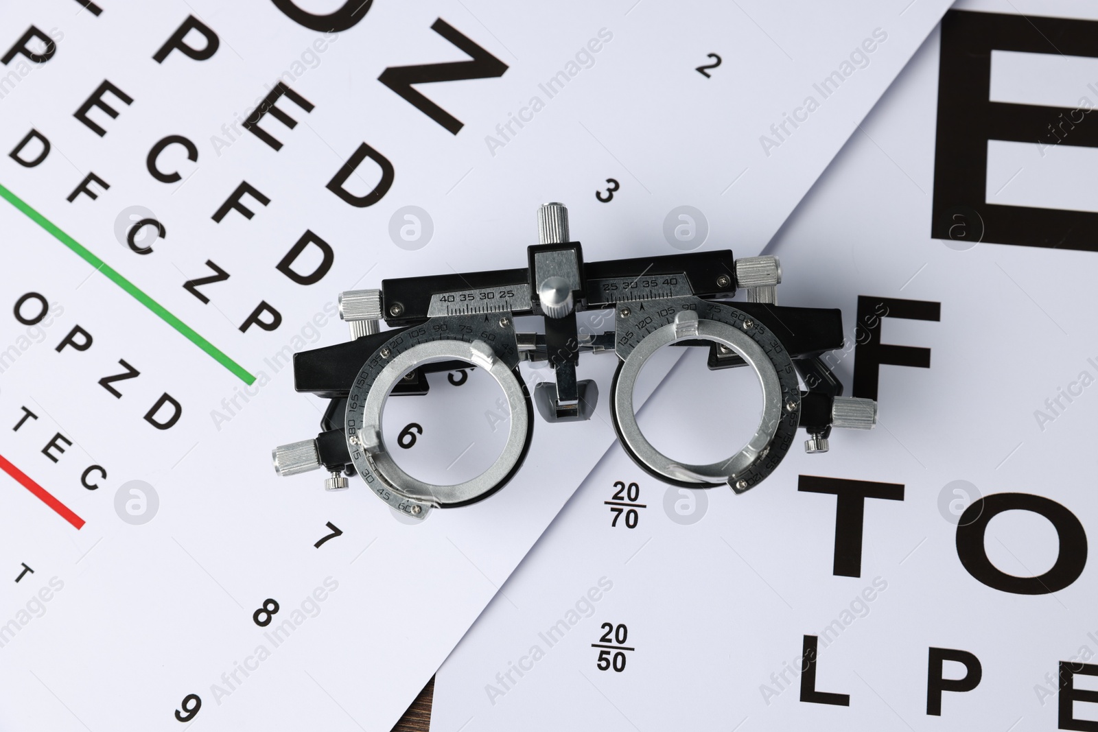 Vision test charts and trial frame on table, top view Photo of Vision test charts and trial frame on table, top view