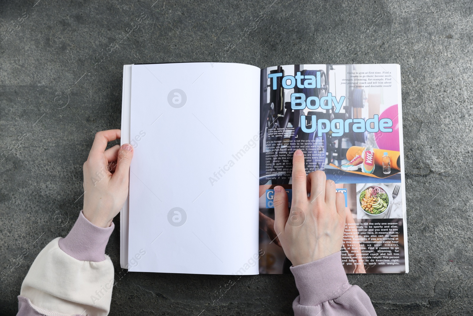 Woman reading magazine at grey table, top view. Mockup for design Photo of Woman reading magazine at grey table, top view. Mockup for design