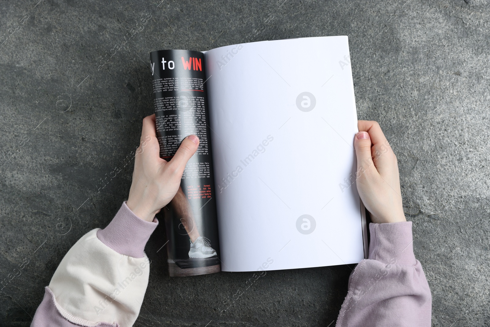 Woman reading magazine at grey table, top view. Mockup for design Photo of Woman reading magazine at grey table, top view. Mockup for design
